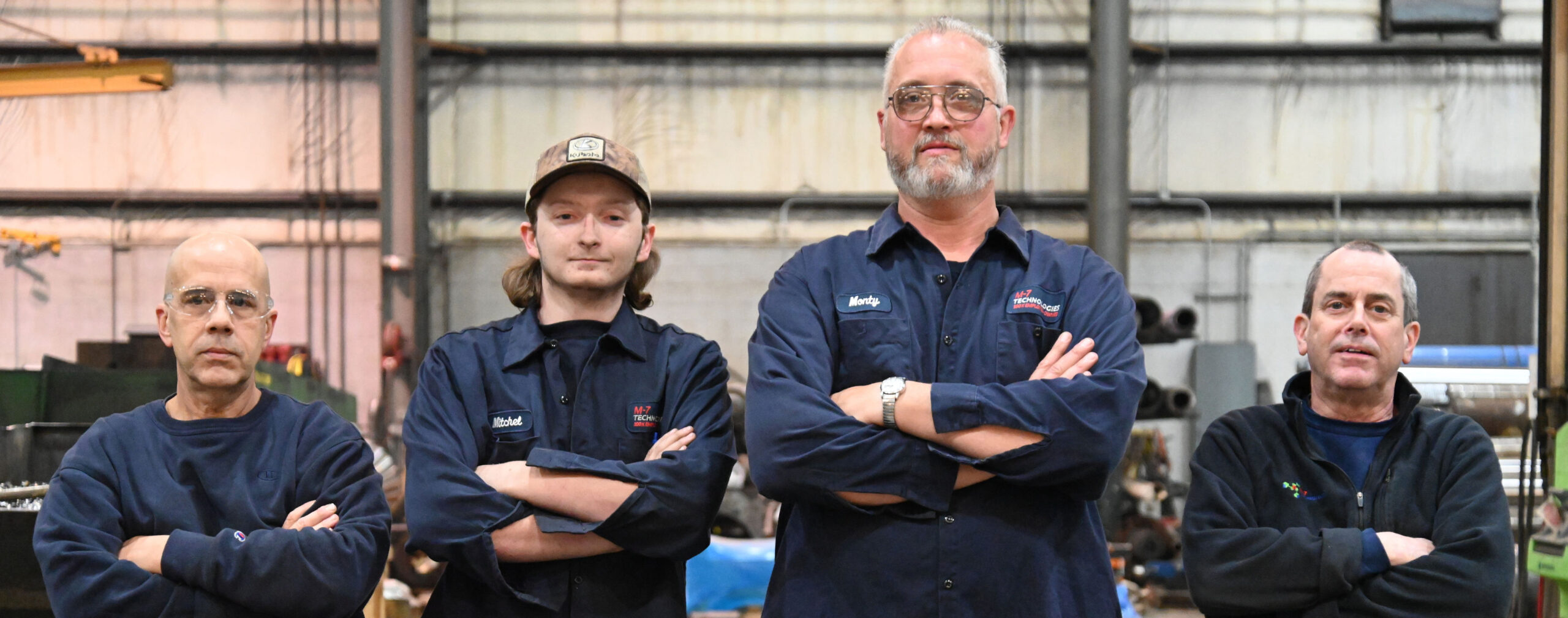 For M7 Technologies technicians with arms crossed looking at the camera.